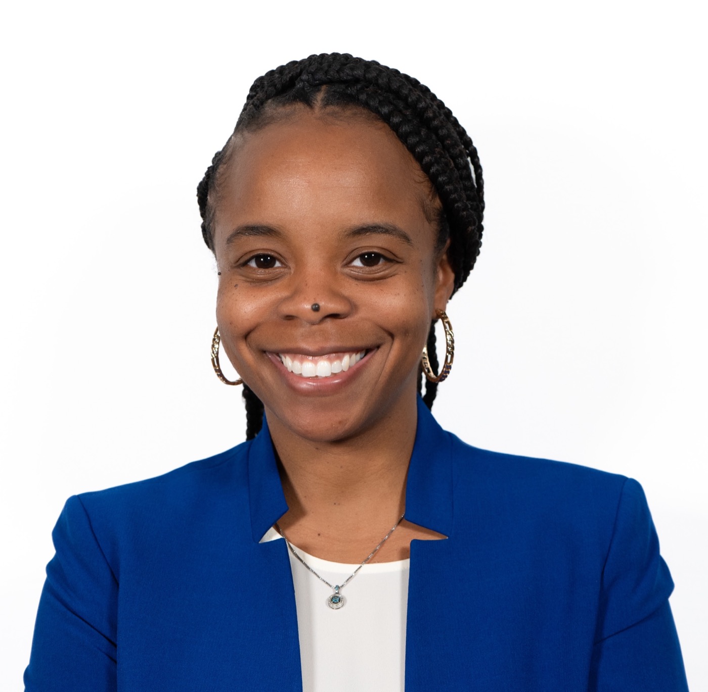 Jenisha Parchment, smiling, in a royal blue blazer